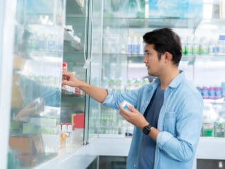 A man is buying medicines to treat his condition in a pharmacy