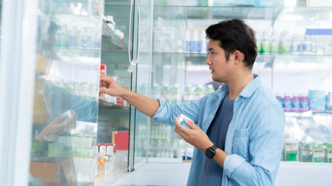 A man is buying medicines to treat his condition in a pharmacy