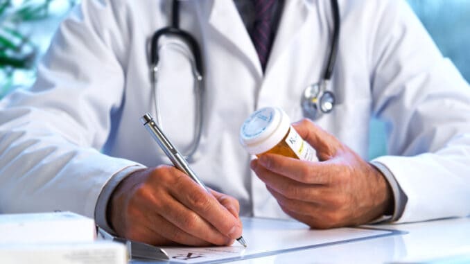 dreamstime_s_23412943 Doctor writing out RX prescription selective focus