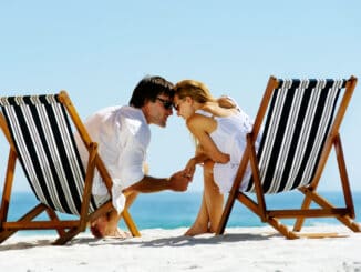 Young couple at the beach in summer share an intimate moment of love and affection