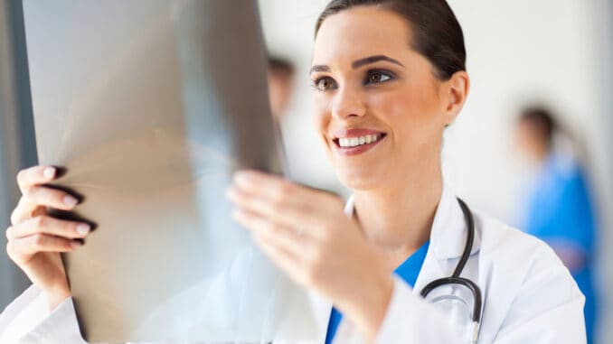 dreamstime_s_27012217 Happy medical doctor looking at x-ray film