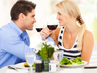 Loving young couple drinking wine in restaurant