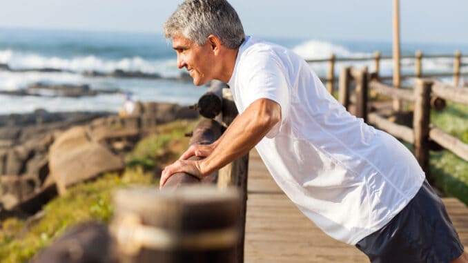 Fit senior man exercising at the beach in the morning