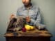 Man unpacking his lunch at an old desk