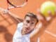 Young man playing tennis outdoors