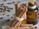 Cinnamon sticks and bottle with oil closeup