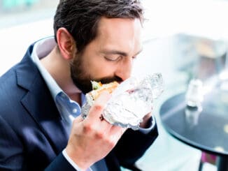 Man eating Doner Kebap in bistro