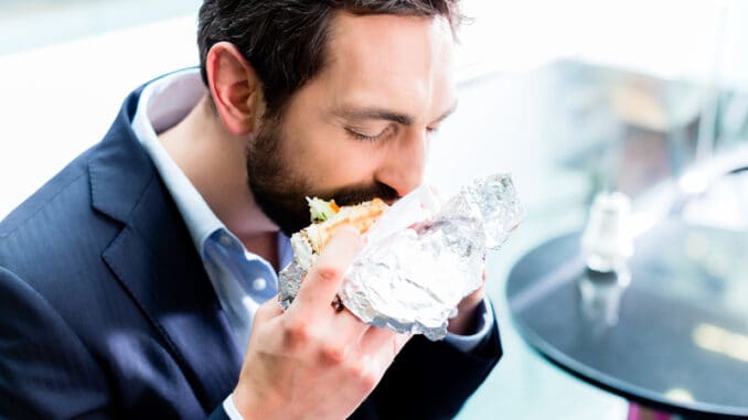 Man eating Doner Kebap in bistro