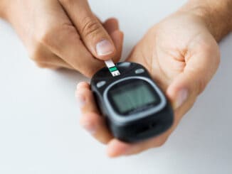 man checking blood sugar level