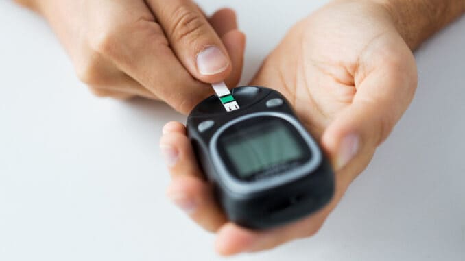 man checking blood sugar level