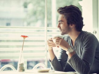 Young man drinking coffee in the cafe