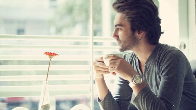 dreamstime_s_60844404 Young man drinking coffee in the cafe