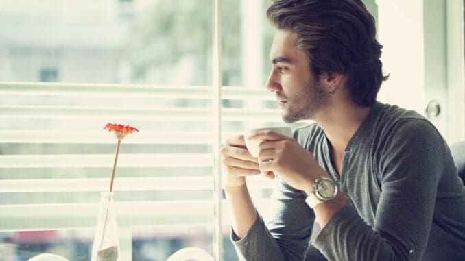 Young man drinking coffee in the cafe