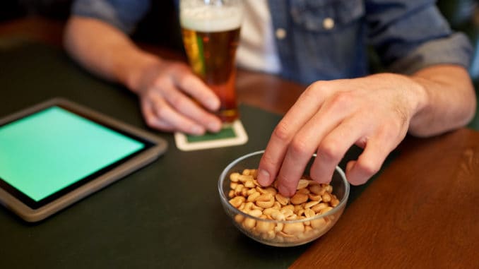 eating peanuts at bar