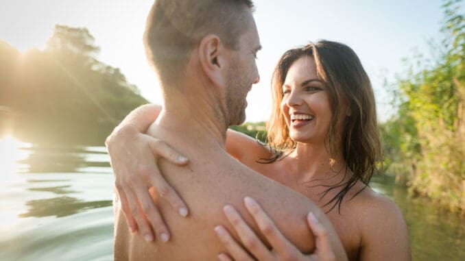 dreamstime_s_88882305 Smiling nude couple hugging in the lake on sunny day