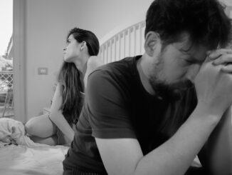Unhappy couple feeling angry after fight in bed