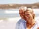 Happy mature couple embracing on a sunny day at the beach