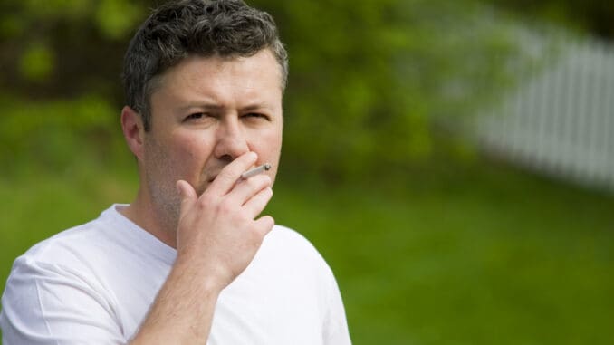 Portrait of a handsome middle eastern man smoking