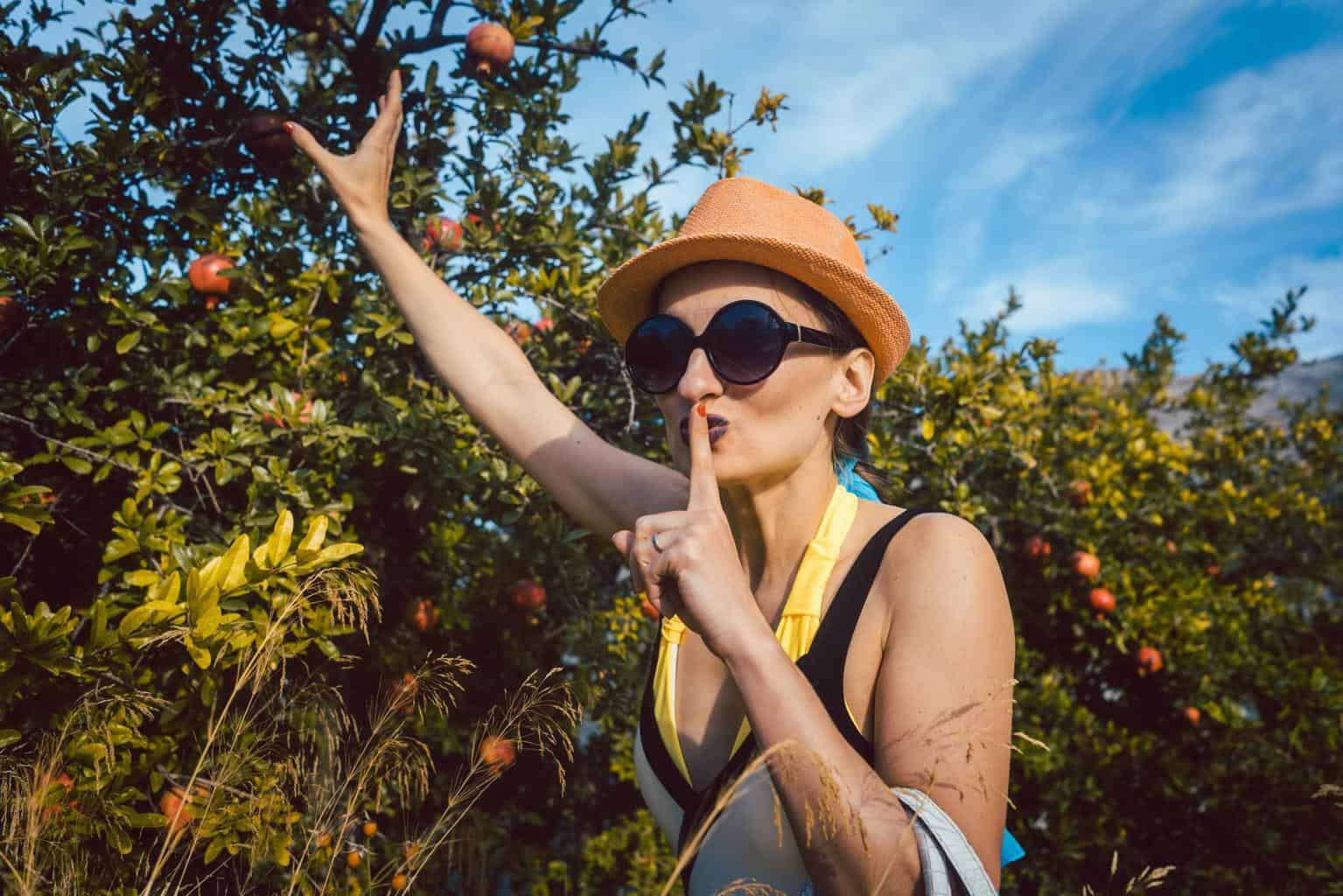 Women silently taking pomegranates